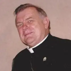 A man in black is wearing a priest 's collar.