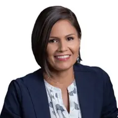 A woman in a blue jacket and white shirt